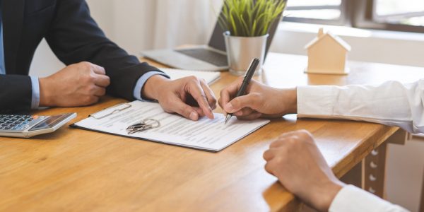 Asian landlord, realtor man pointing on paper for sign signature contract with tenant rental or client, realtor purchase, buyer home or apartment, agreement mortgage, property lease agent concept.